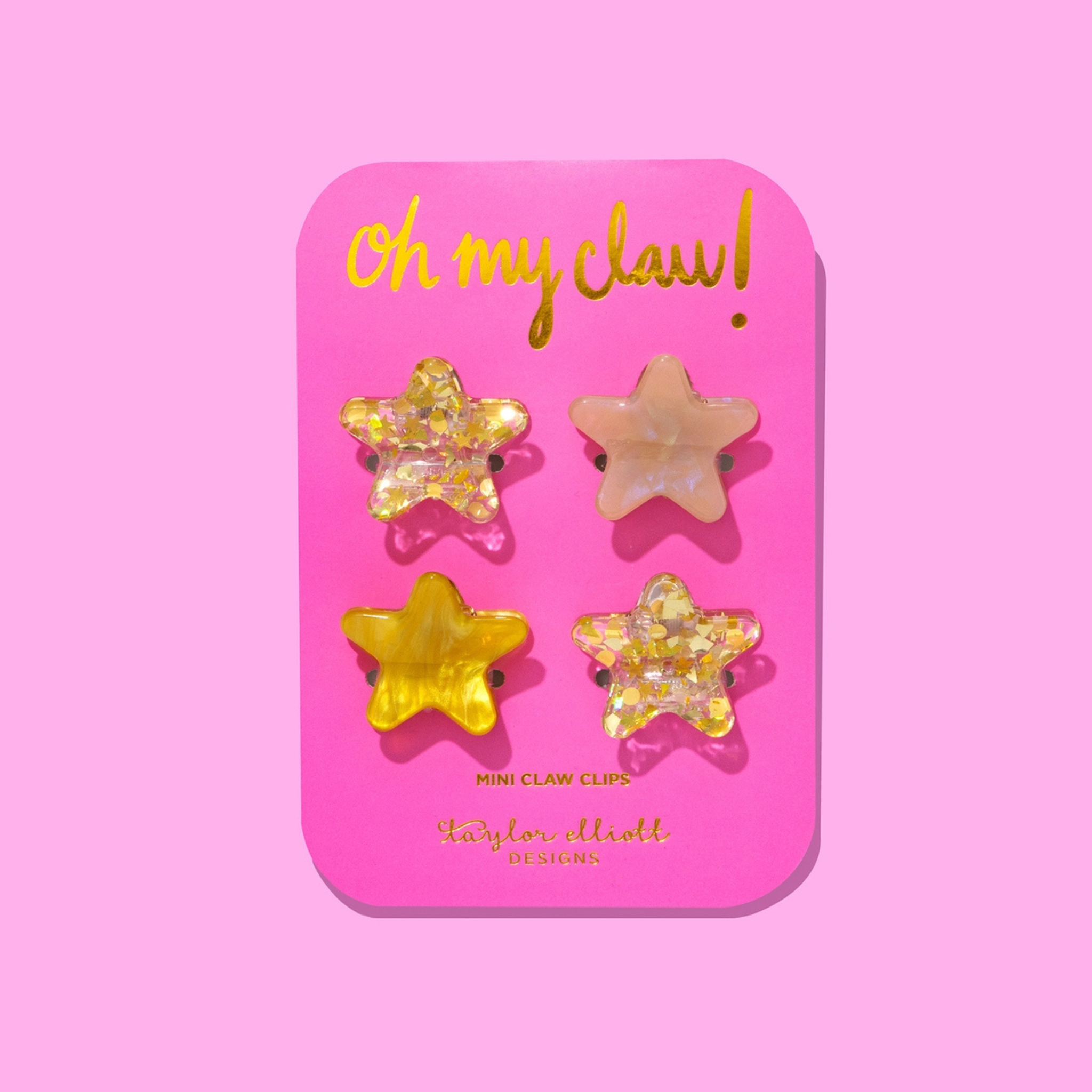 Set of four mini gold star glitter hair clips for girls, perfect as a festive stocking stuffer or holiday accessory, shown on white background