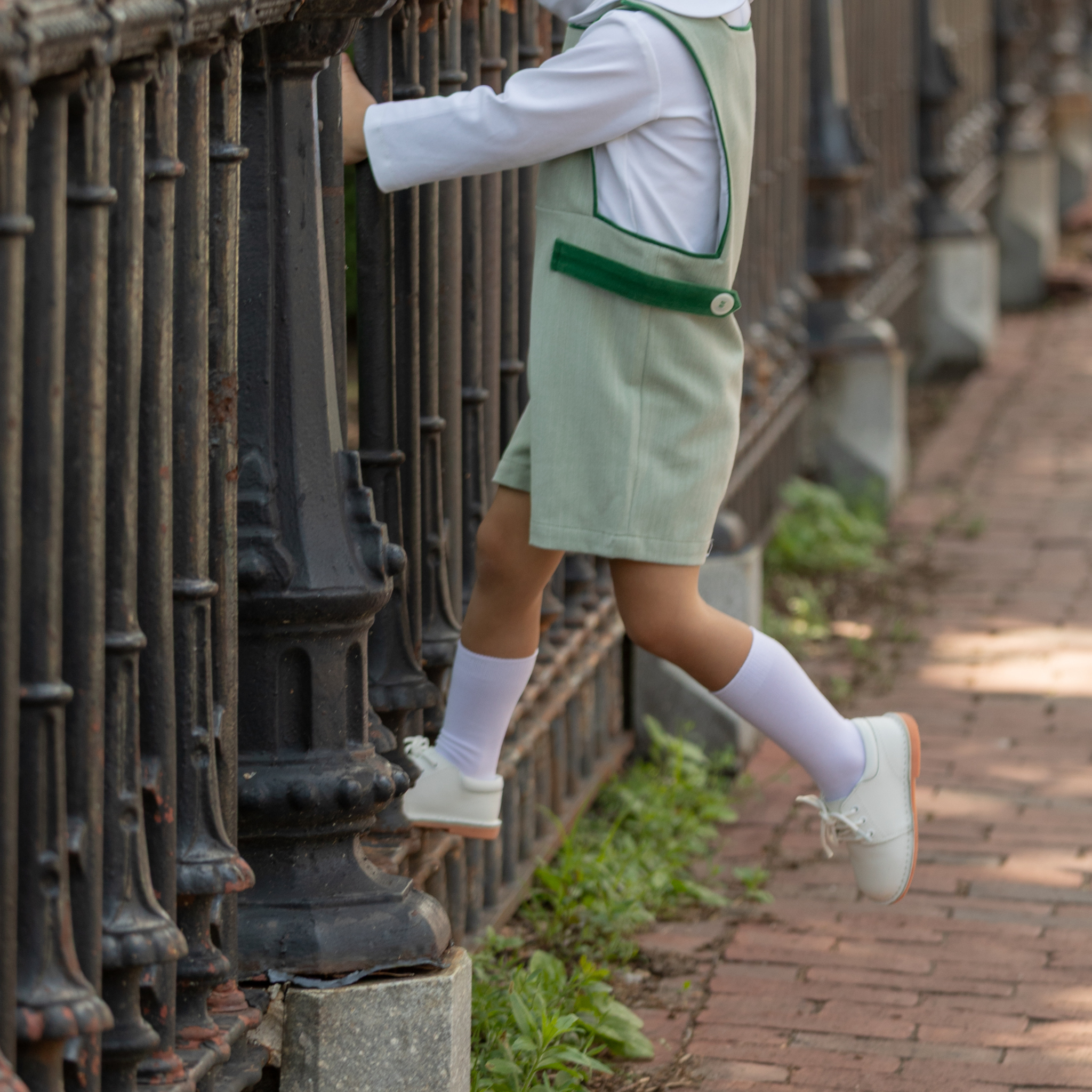 Classic white nylon knee high socks for girls and toddlers, lightweight with ribbed stay-up top, designed for comfort and perfect fit, ideal for pairing with Mary Janes or dress shoes from Henry Duvall’s Fall Collection