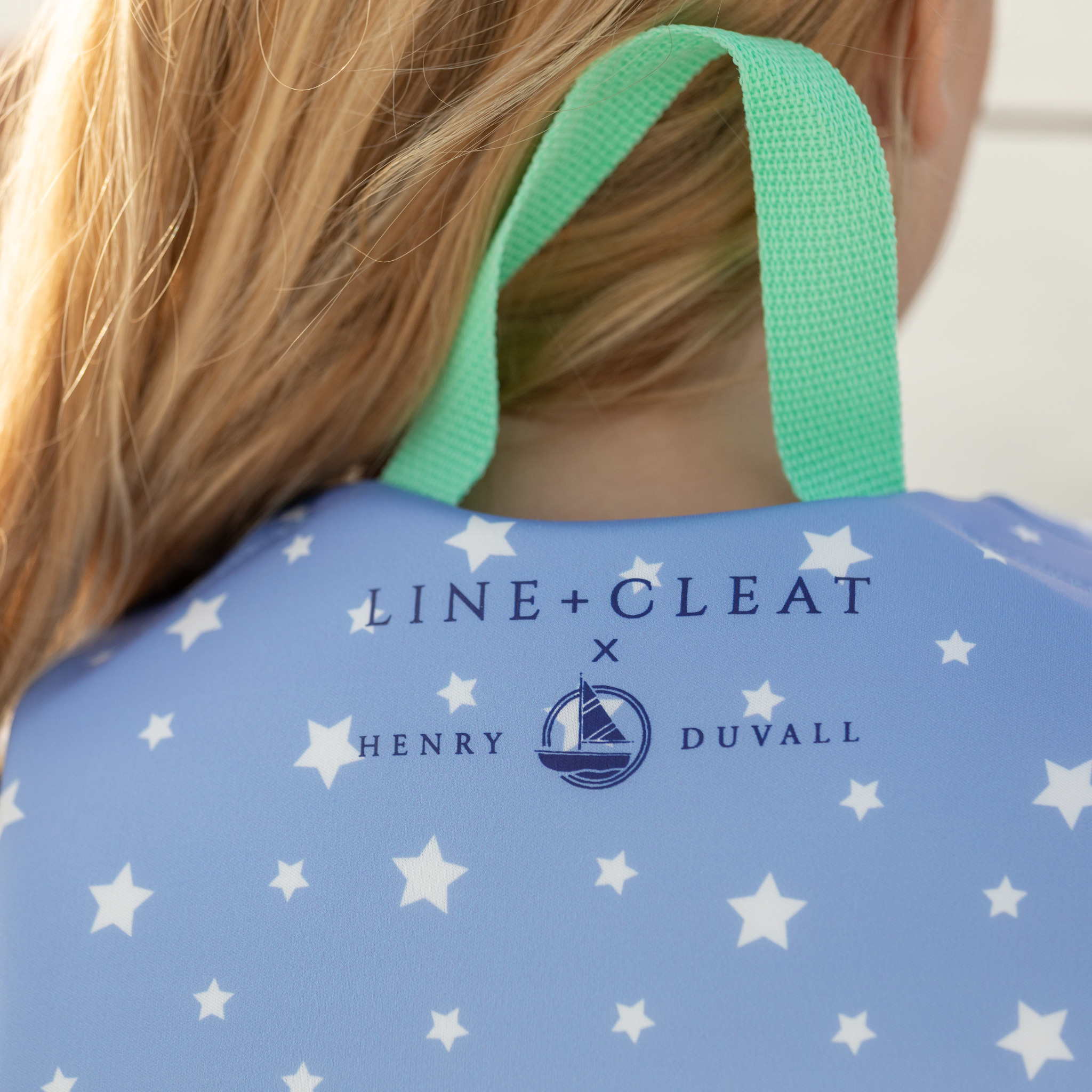 Stylish Henry Duvall x Line + Cleat kids life jacket in blue star print with zipper front and adjustable safety straps