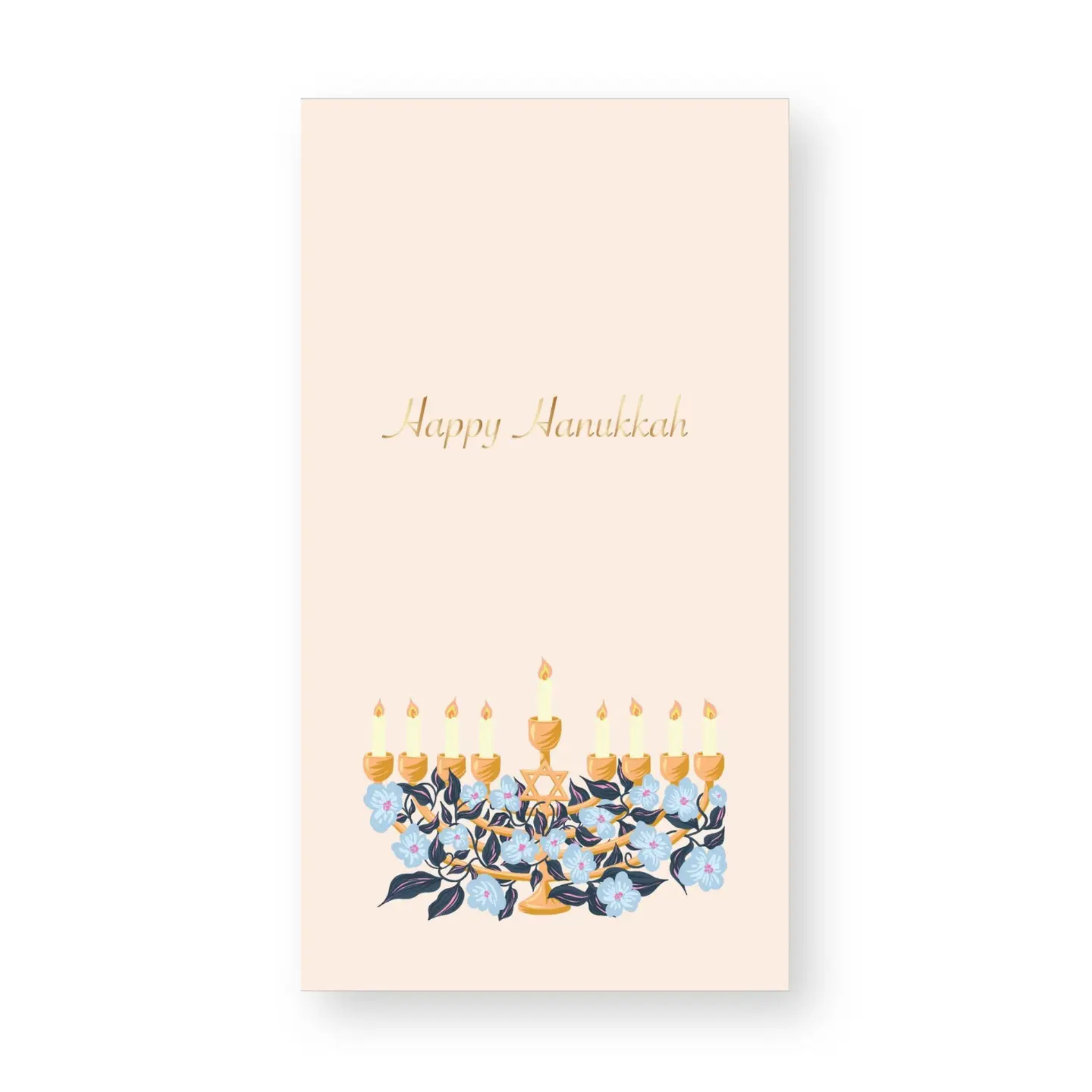 Hanukkah guest towel featuring a gold menorah with blue floral accents and “Happy Hanukkah” written in gold script on a soft blush background; ideal for festive holiday gatherings