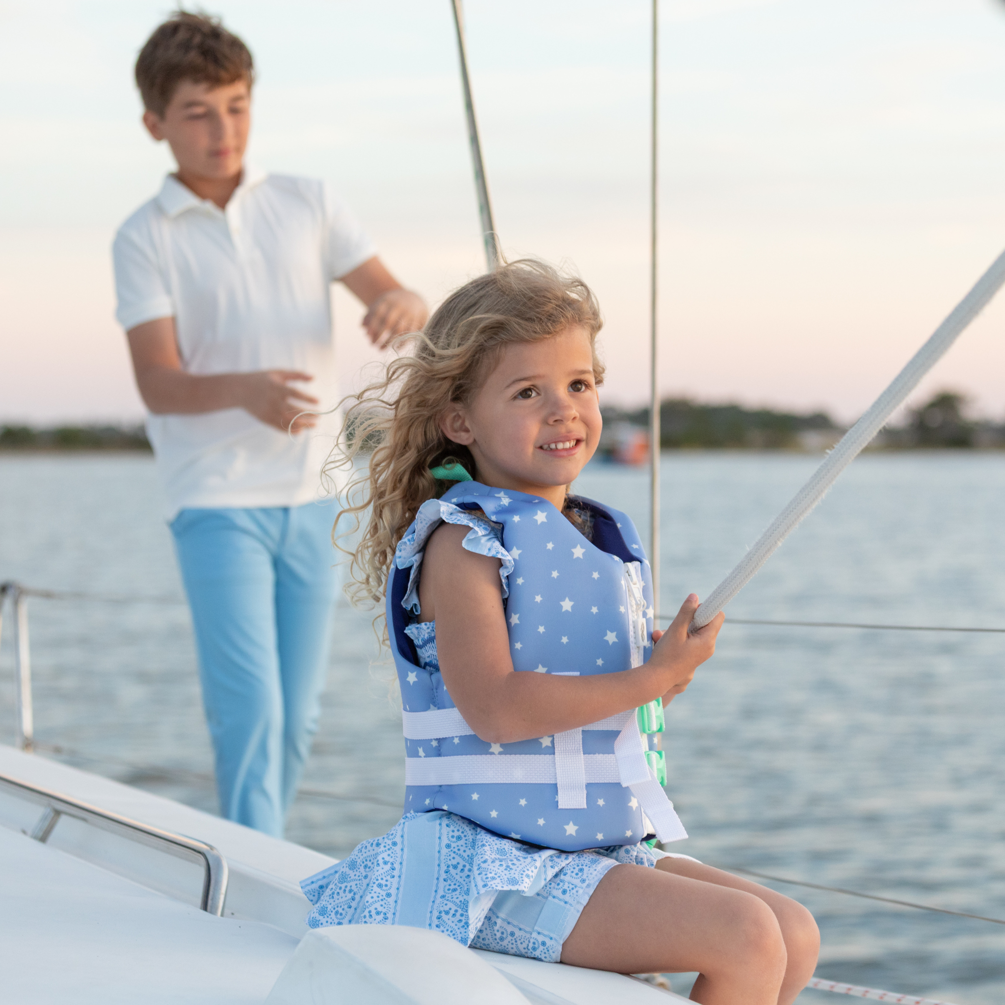 Stylish Henry Duvall x Line + Cleat kids life jacket in blue star print with zipper front and adjustable safety straps