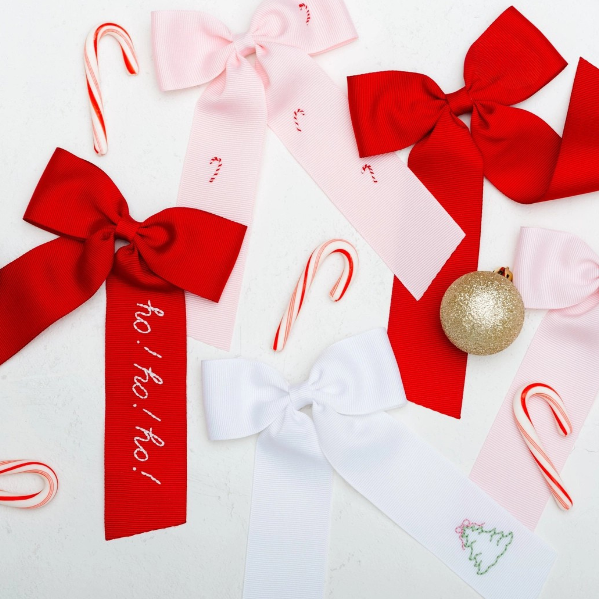 Red bow with 'ho! ho! ho!' text on a white background