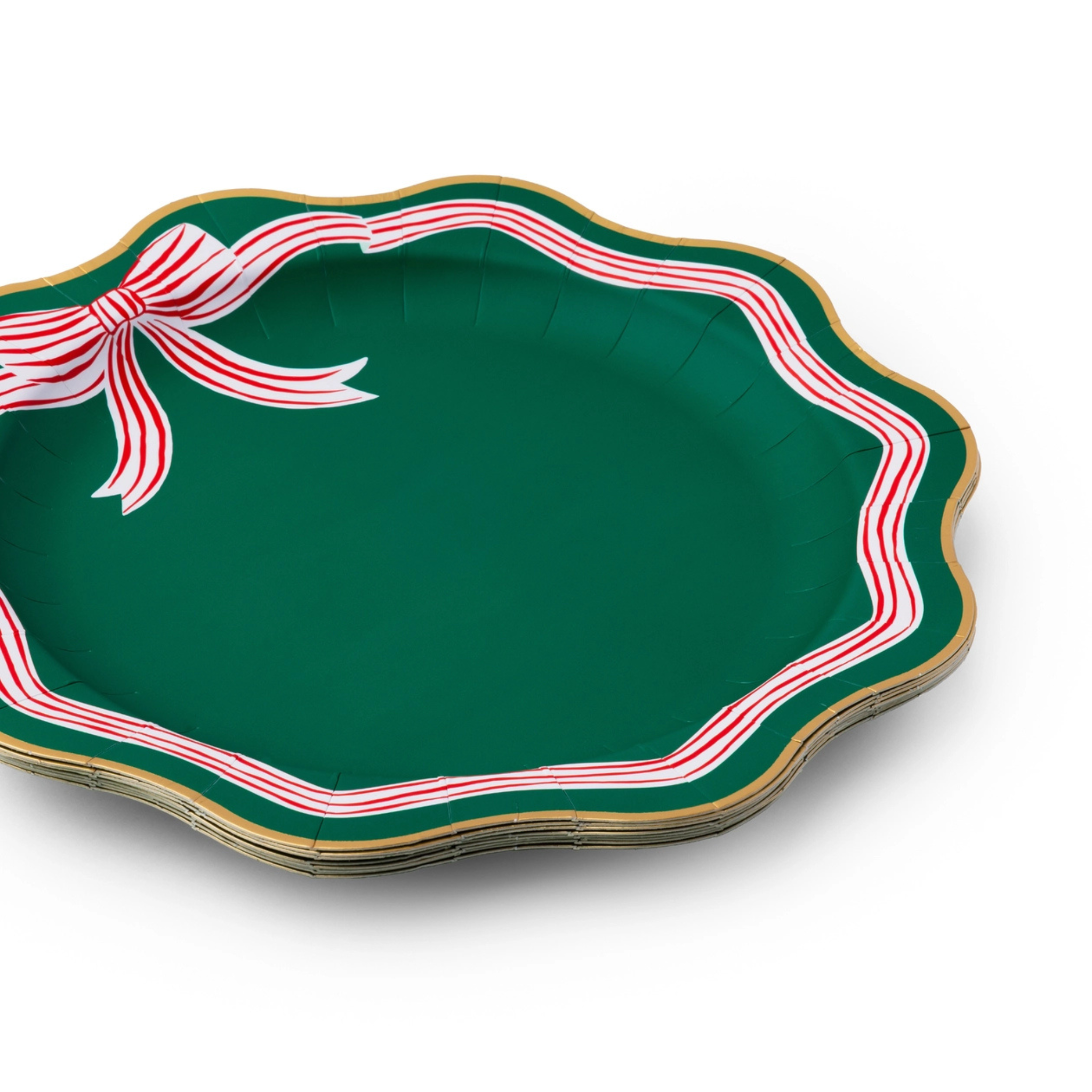 Holiday dinner plates with scalloped edges and red peppermint bow design in pink and green tones, perfect for festive Christmas table settings
