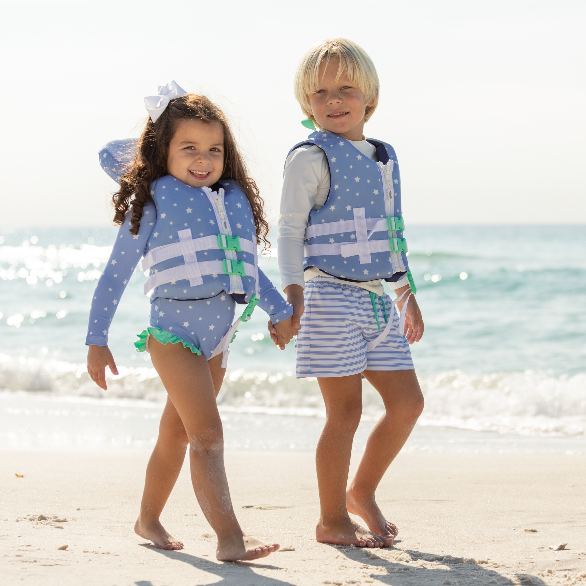 Stylish Henry Duvall x Line + Cleat infant life jacket in blue star print with neck pillow support, zipper front, and adjustable straps