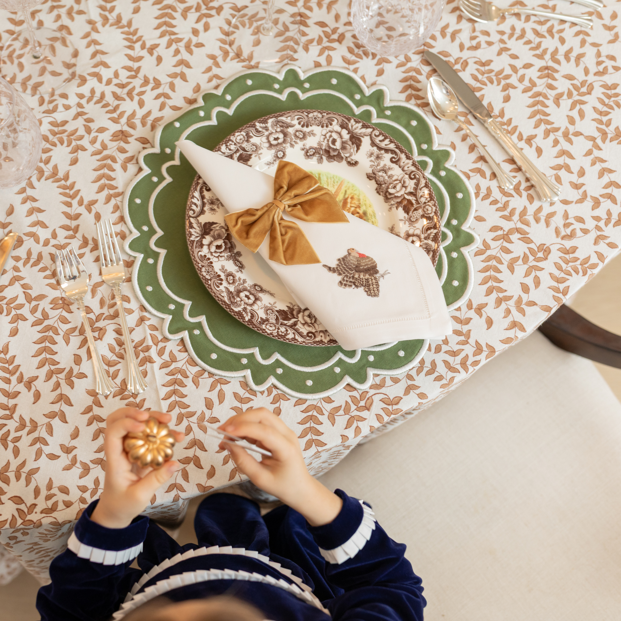Classic round green scalloped placemats with white embroidery, perfect for Thanksgiving or holiday table settings, handcrafted from a premium cotton blend.