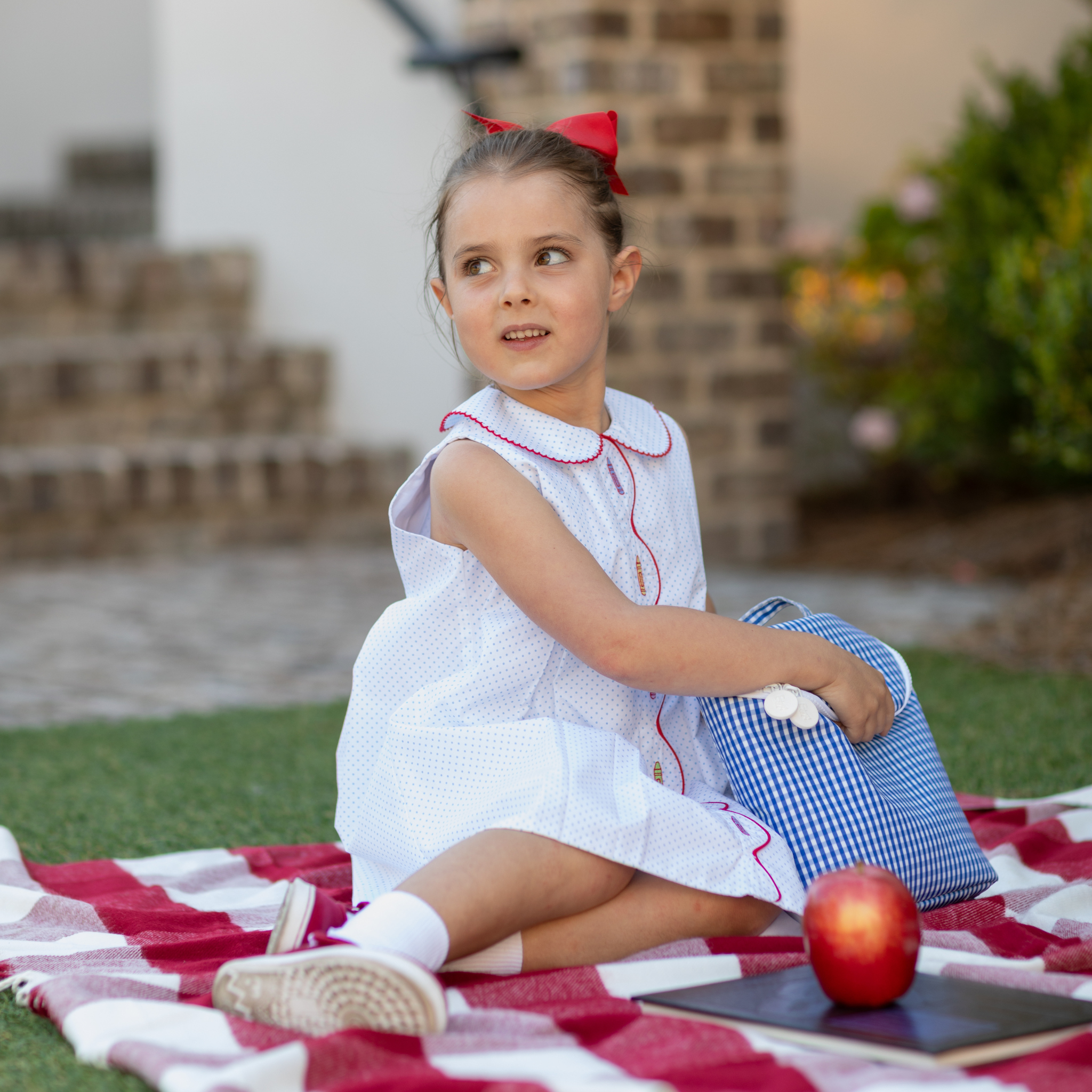 Henry Duvall Lucy Dress in blue micro dot cotton featuring a Peter Pan collar, red scalloped trim, and embroidered crayons, classic girls back-to-school dress for first day of school photos and classroom celebrations.