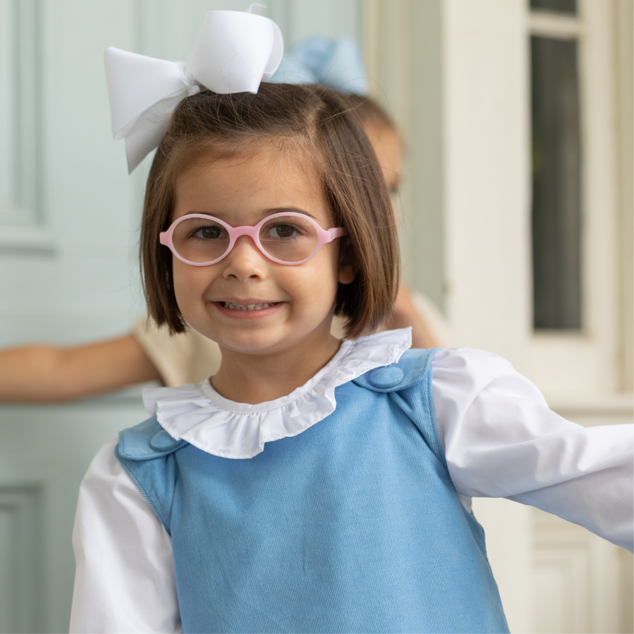 Henry Duvall Janie Jumper girls’ dress in Brookhaven Blue corduroy with scalloped hem and fabric-covered shoulder buttons, designed for layering with blouses and turtlenecks for fall.