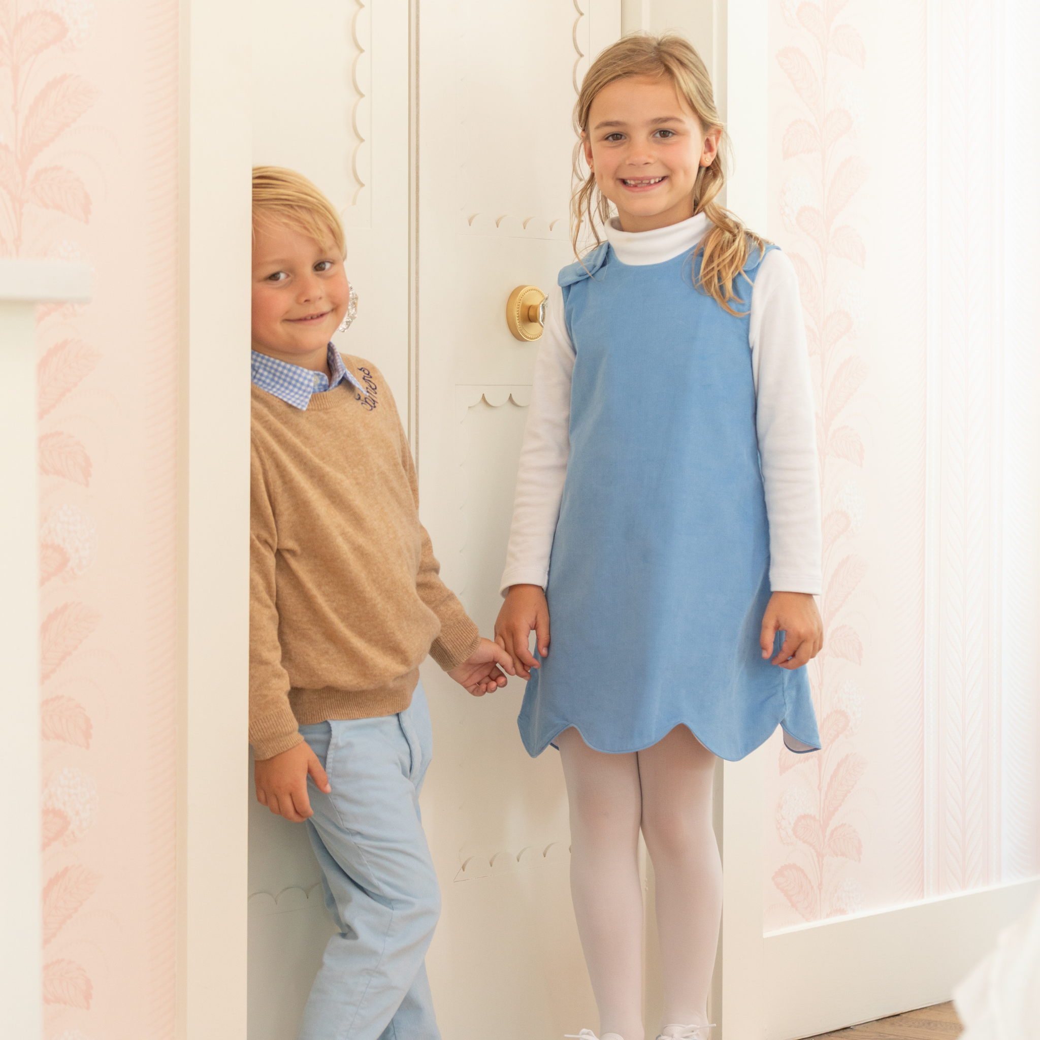 Henry Duvall Janie Jumper girls’ dress in Brookhaven Blue corduroy with scalloped hem and fabric-covered shoulder buttons, designed for layering with blouses and turtlenecks for fall.