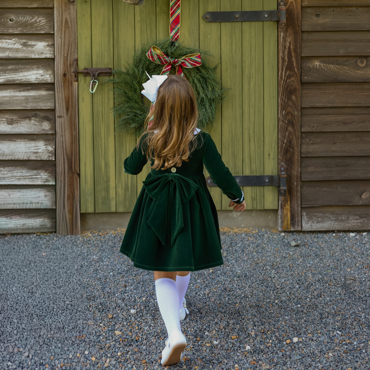 Baby girls’ Long Sleeve Grace Bubble in Grafton Green Velvet with a white pleated collar, waist and cuff trim.