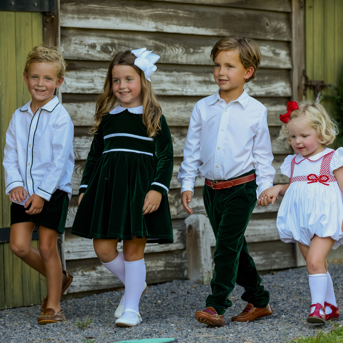 Baby girls’ Long Sleeve Grace Bubble in Grafton Green Velvet with a white pleated collar, waist and cuff trim.