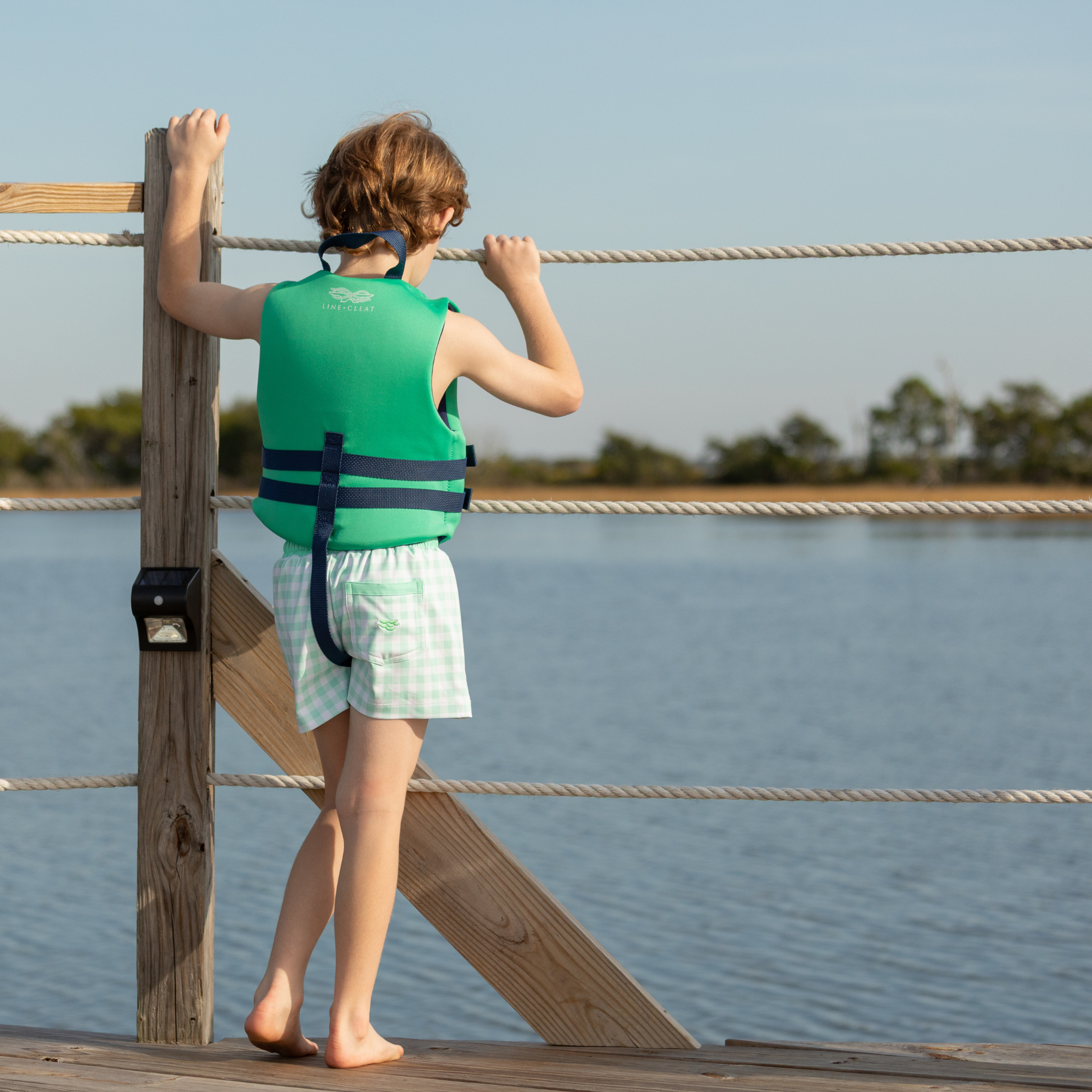 Classic boys’ swim trunks by Henry Duvall in a tailored above-the-knee fit with UPF 50+ protection, featuring an elastic waistband and drawstring for a comfortable summer look.