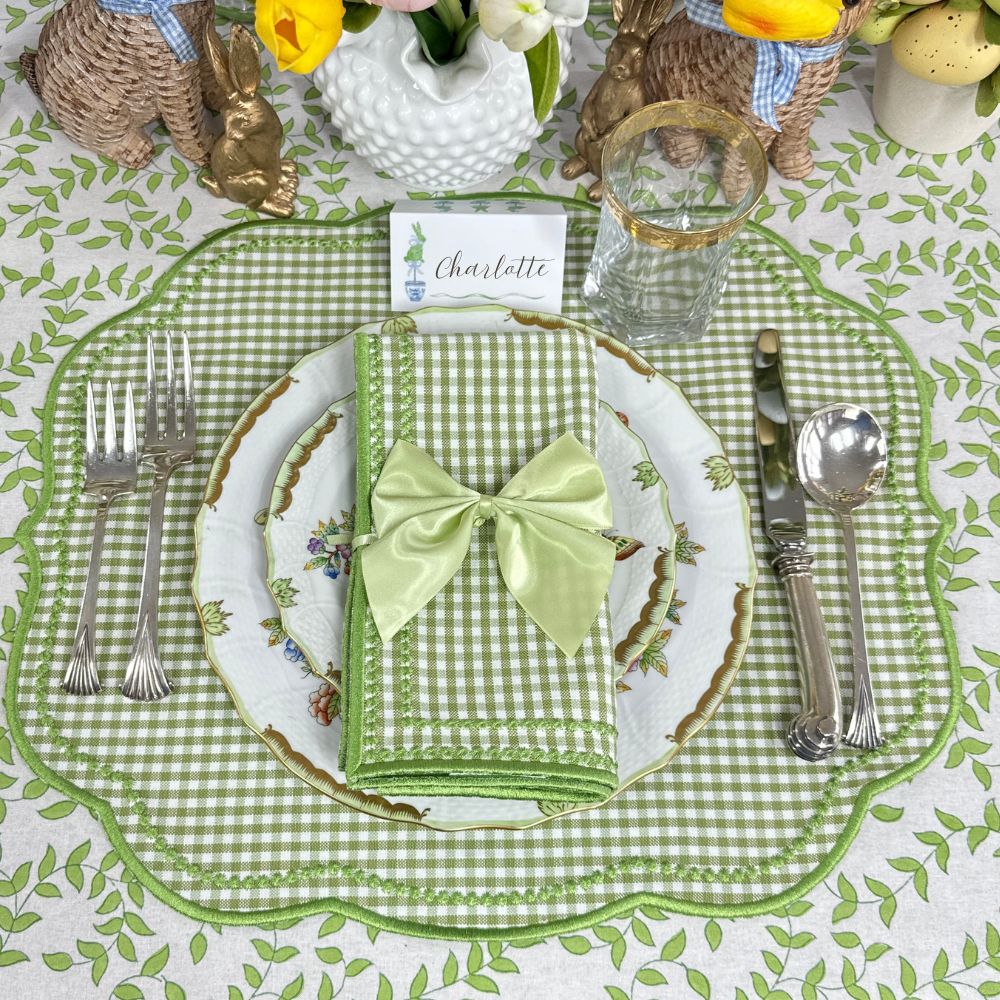 Easter table setting with green checkered placemat, white plate, and decorative napkin.