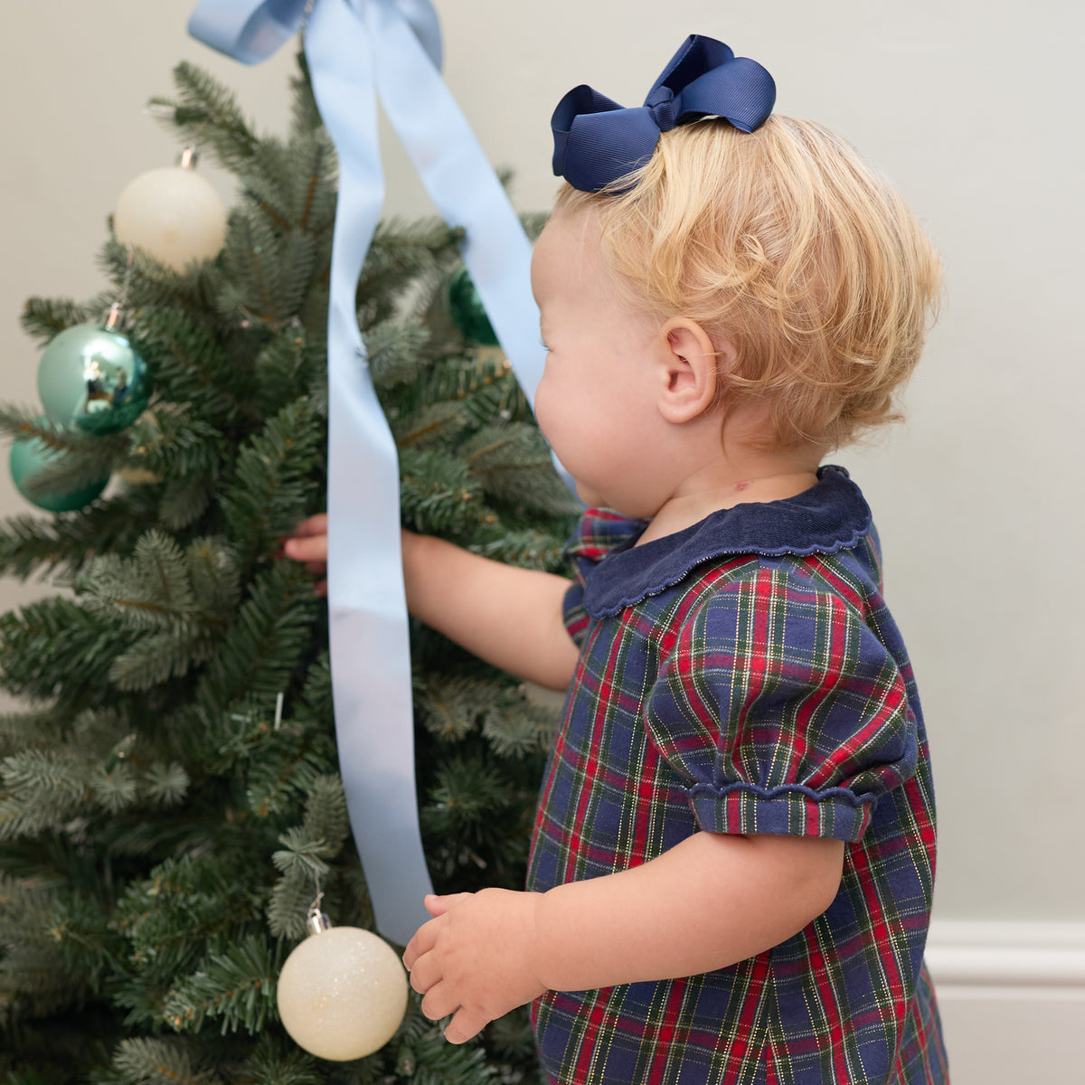 Girls’ Beatrice Bubble in navy, red, and green Tinsel Tartan with subtle metallic thread, Midnight Blue Corduroy scalloped collar, and scalloped sleeve trim.