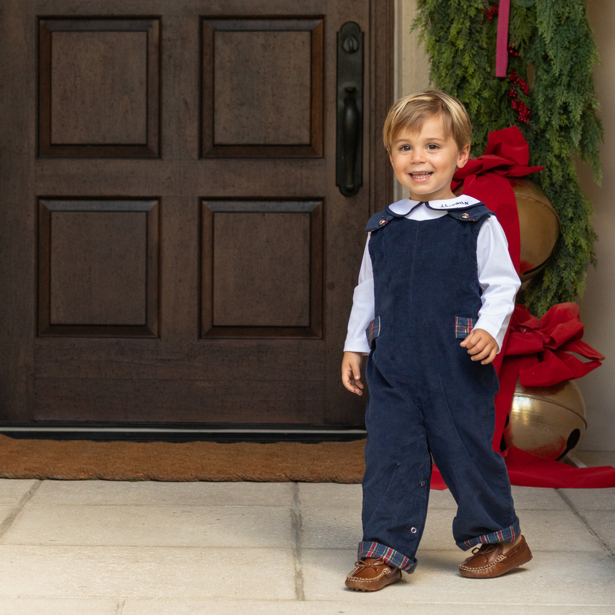 Boys’ Louis Longall in Midnight Blue Corduroy with Tinsel Tartan tabs, HD gold buttons, and full tartan lining designed to show when the cuffs are rolled.
