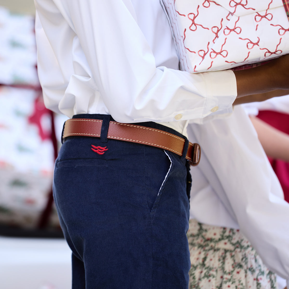 Boys’ Bradford Trousers in Midnight Blue Corduroy, fully lined in Tinsel Tartan with cuffed hems revealing festive navy, red, and green plaid.