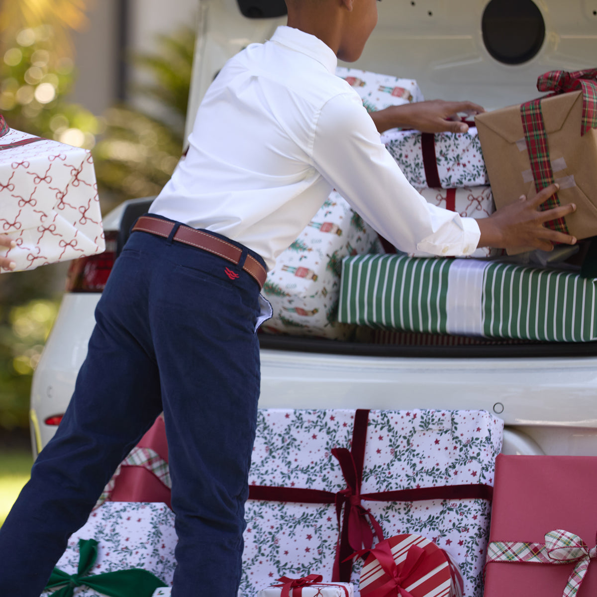 Boys’ Bradford Trousers in Midnight Blue Corduroy, fully lined in Tinsel Tartan with cuffed hems revealing festive navy, red, and green plaid.