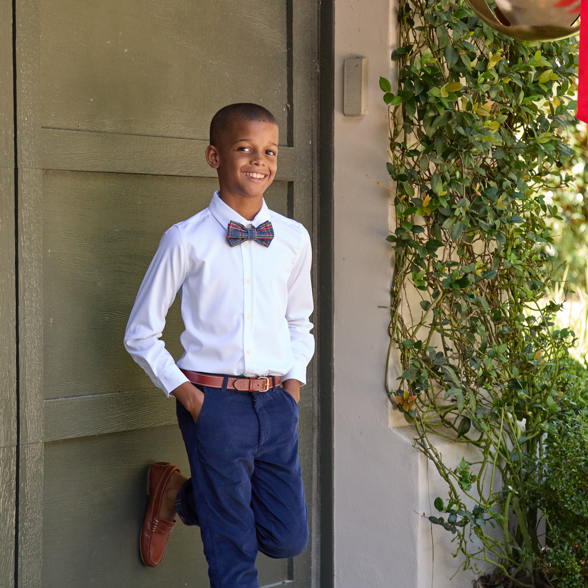Boys’ pre-tied Baker Bow Tie in navy, red, and green Tinsel Tartan with subtle metallic thread and easy-on clasp.