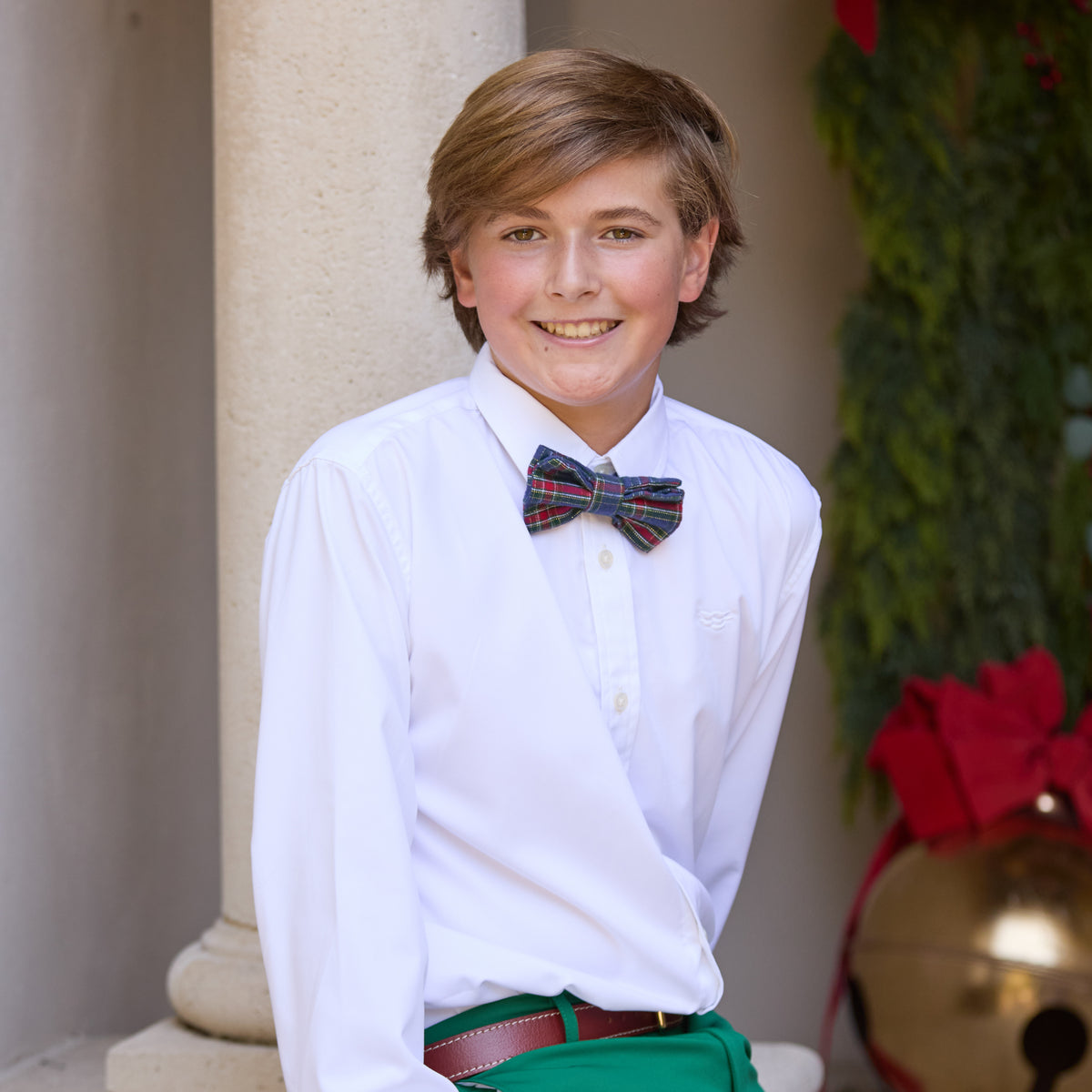 Boys’ pre-tied Baker Bow Tie in navy, red, and green Tinsel Tartan with subtle metallic thread and easy-on clasp.