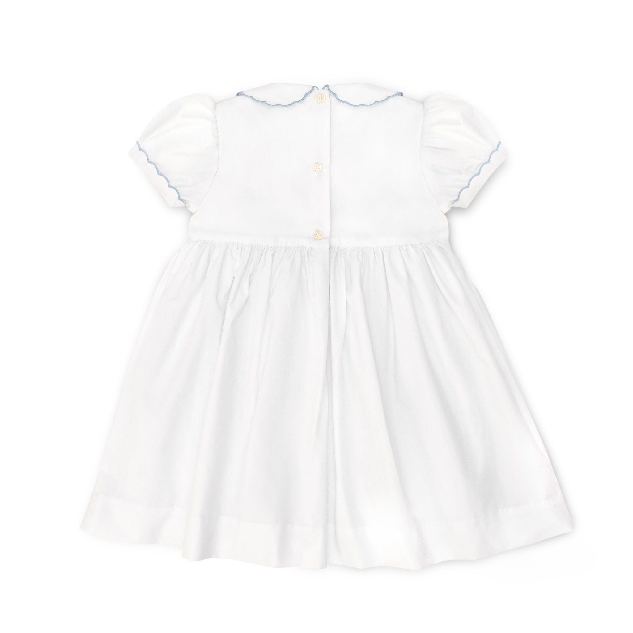 Henry Duvall Eloise Dress in white cotton with Bailey’s Bay Blue trim and hand-smocked sailboats, classic heirloom baby girl summer outfit with scalloped Peter Pan collar