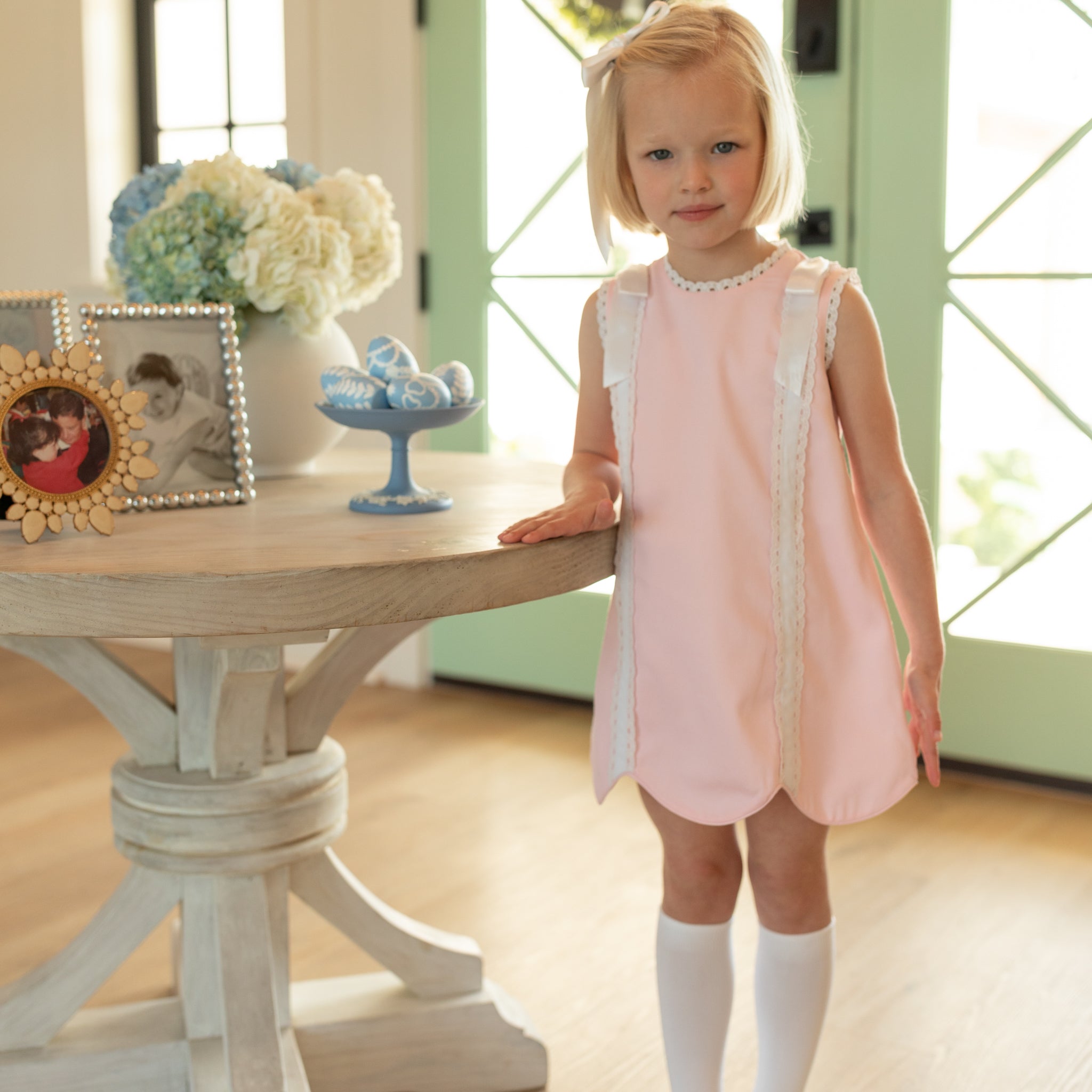 Girl wearing the Henry Duvall Rosie Dress, a classic pink girls dress designed for spring celebrations and family portraits.