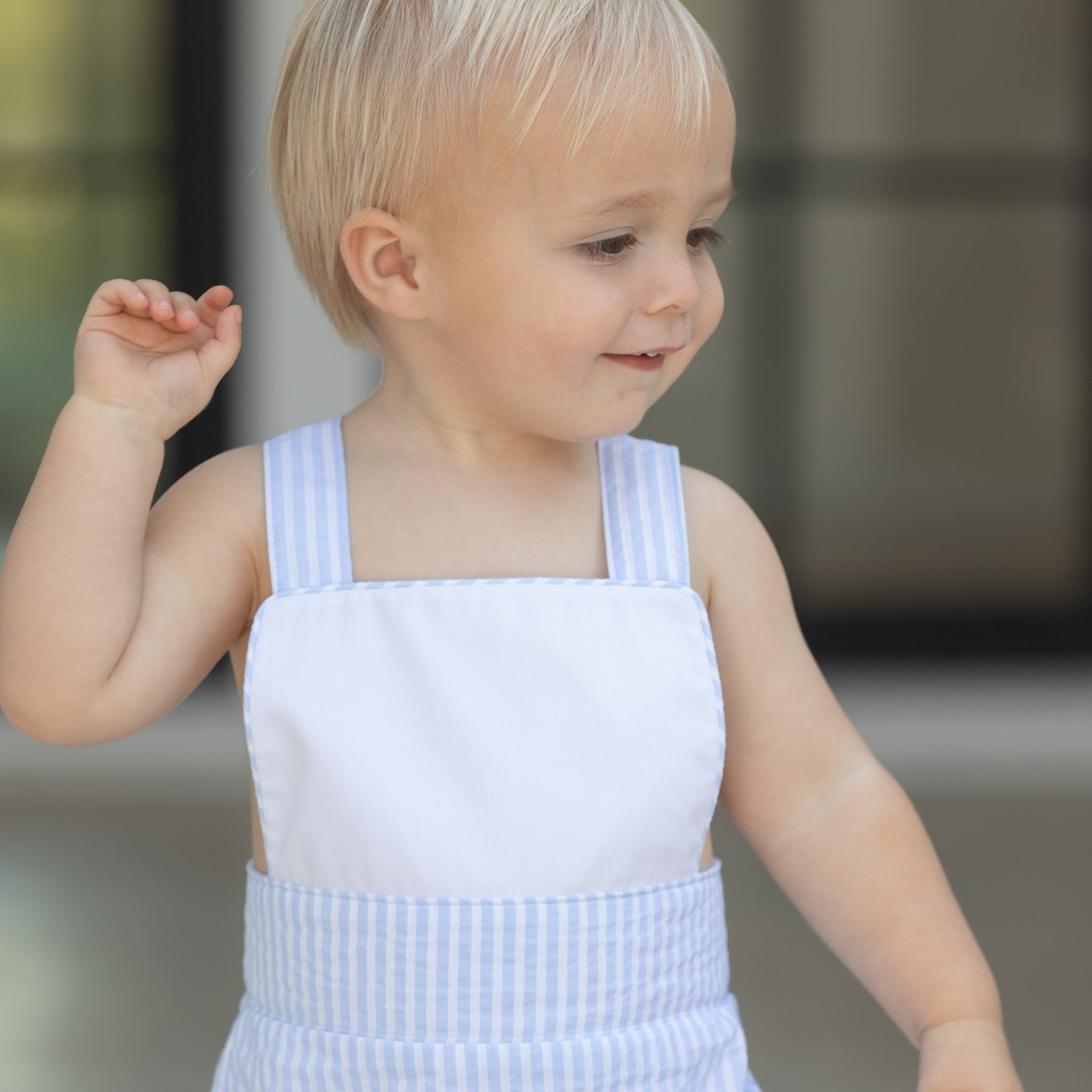 Baby boy wearing the Henry Duvall Henry Sunsuit in Seaside Stripe, a classic summer outfit designed for warm weather and sibling matching.