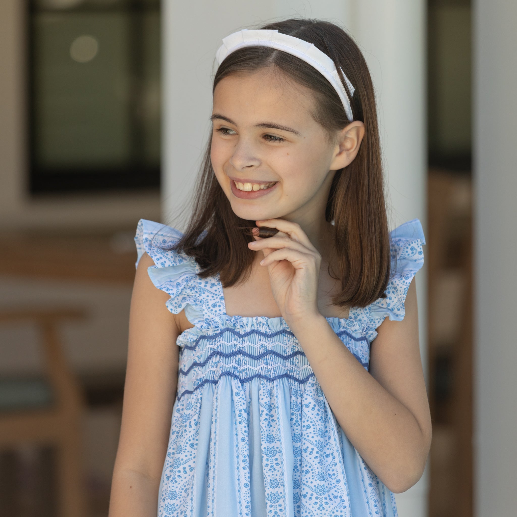 Girl wearing the Henry Duvall smocked shorts set in South Charles Stripe, a classic girls outfit designed for warm weather and family photos.