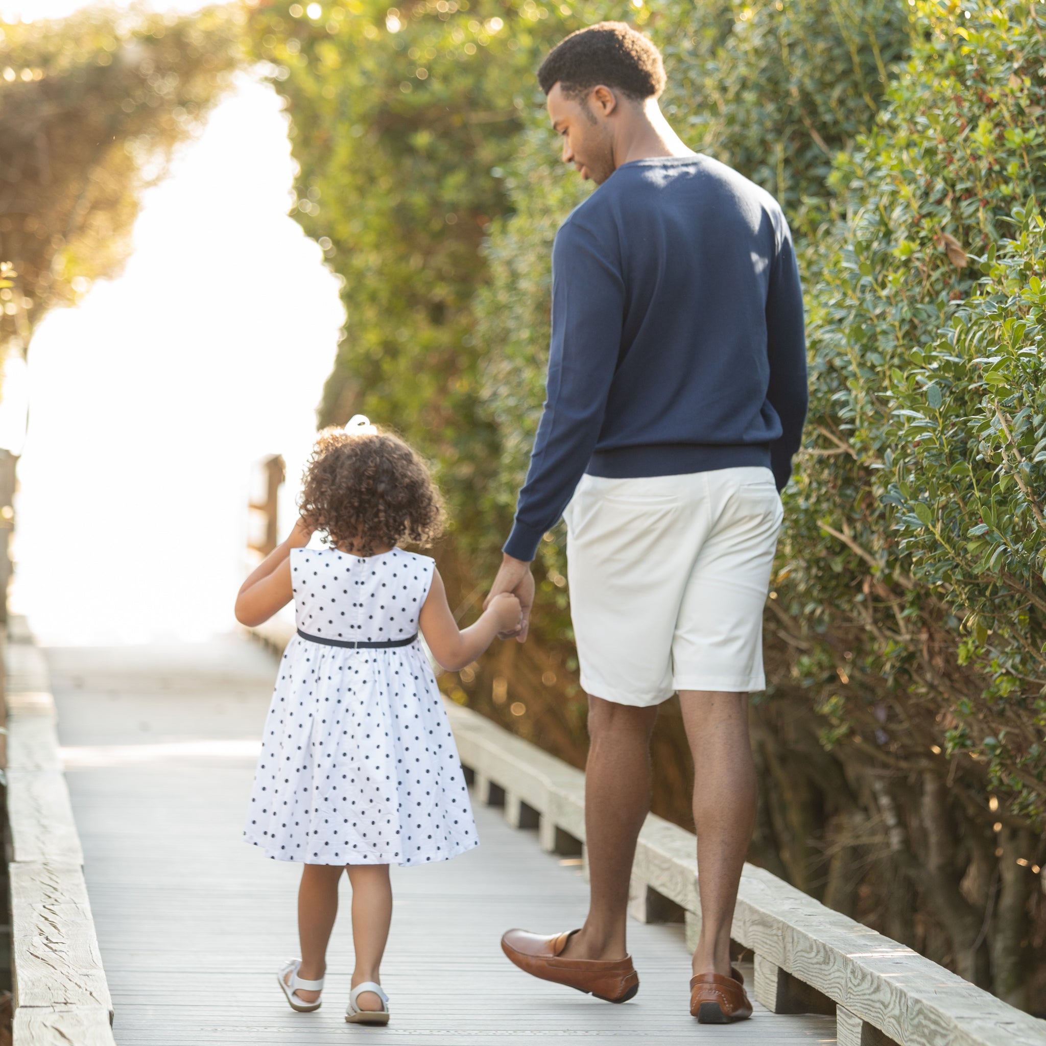 Henry Duvall Betsy Dress in white cotton with navy polka dots and grosgrain bow, classic twirl dress for girls that transitions from summer to fall