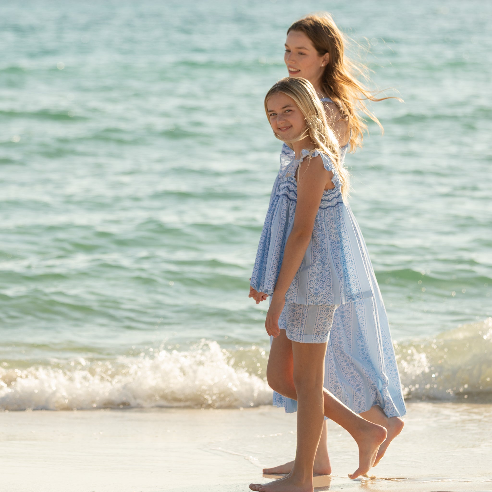 Girl wearing the Henry Duvall smocked shorts set in South Charles Stripe, a classic girls outfit designed for warm weather and family photos.