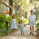 Henry Duvall Leila Dress with back-to-school embroidery, classic blue girls cotton dress with pink trim and heirloom stitching featuring crayons, scissors, and pencils
