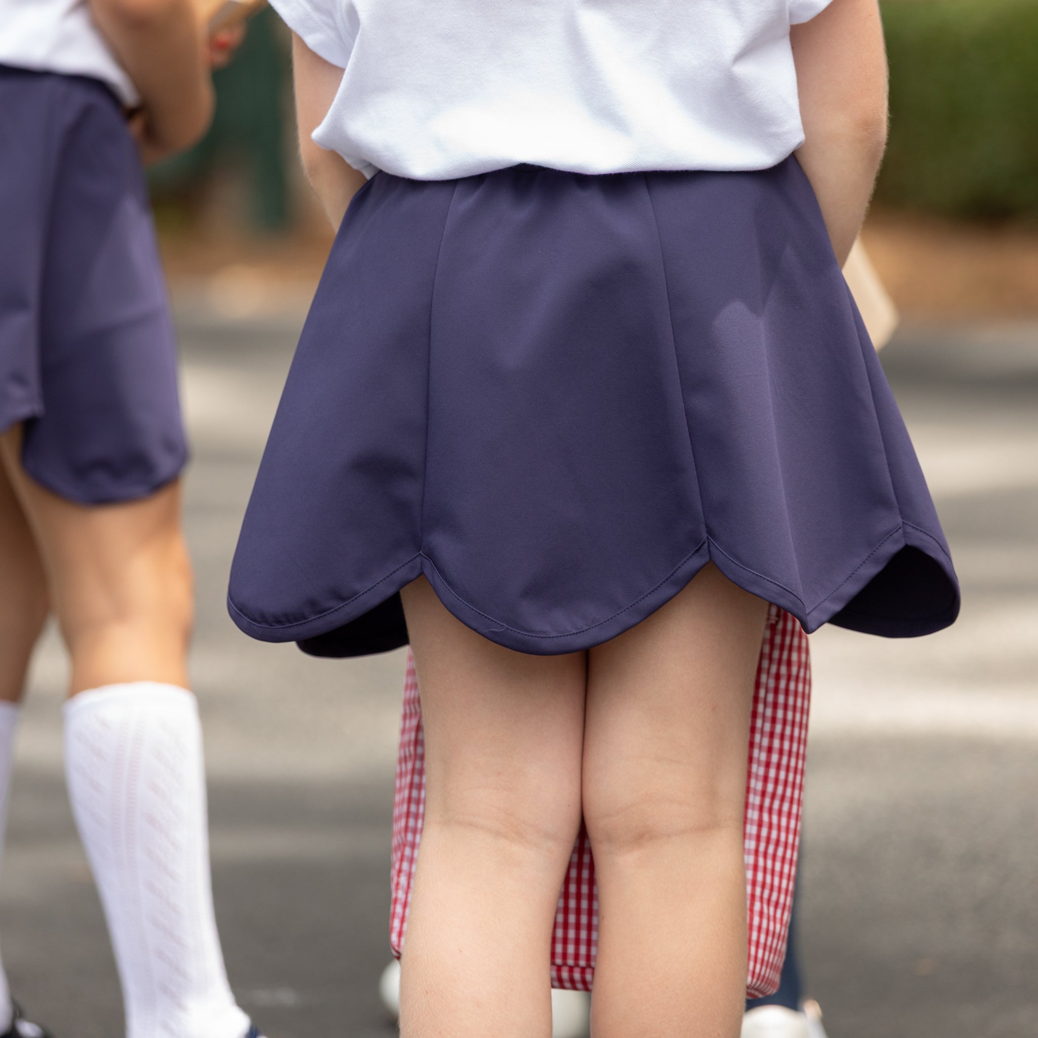 Henry Duvall Scalloped Skort in khaki or navy, performance fabric school skort with scalloped hem, built-in shorts, and hidden pocket—designed by girls for girls