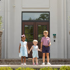 Henry Duvall Jennings Jon Jon with back-to-school embroidery, classic blue toddler boys romper with red trim and heirloom stitching of crayons, scissors, pencils, and ruler