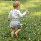 Classic baby boy bubble romper in blue gray herringbone fabric, inspired by English heritage style, heirloom-quality traditional boys clothing for portraits, holidays, and special occasions