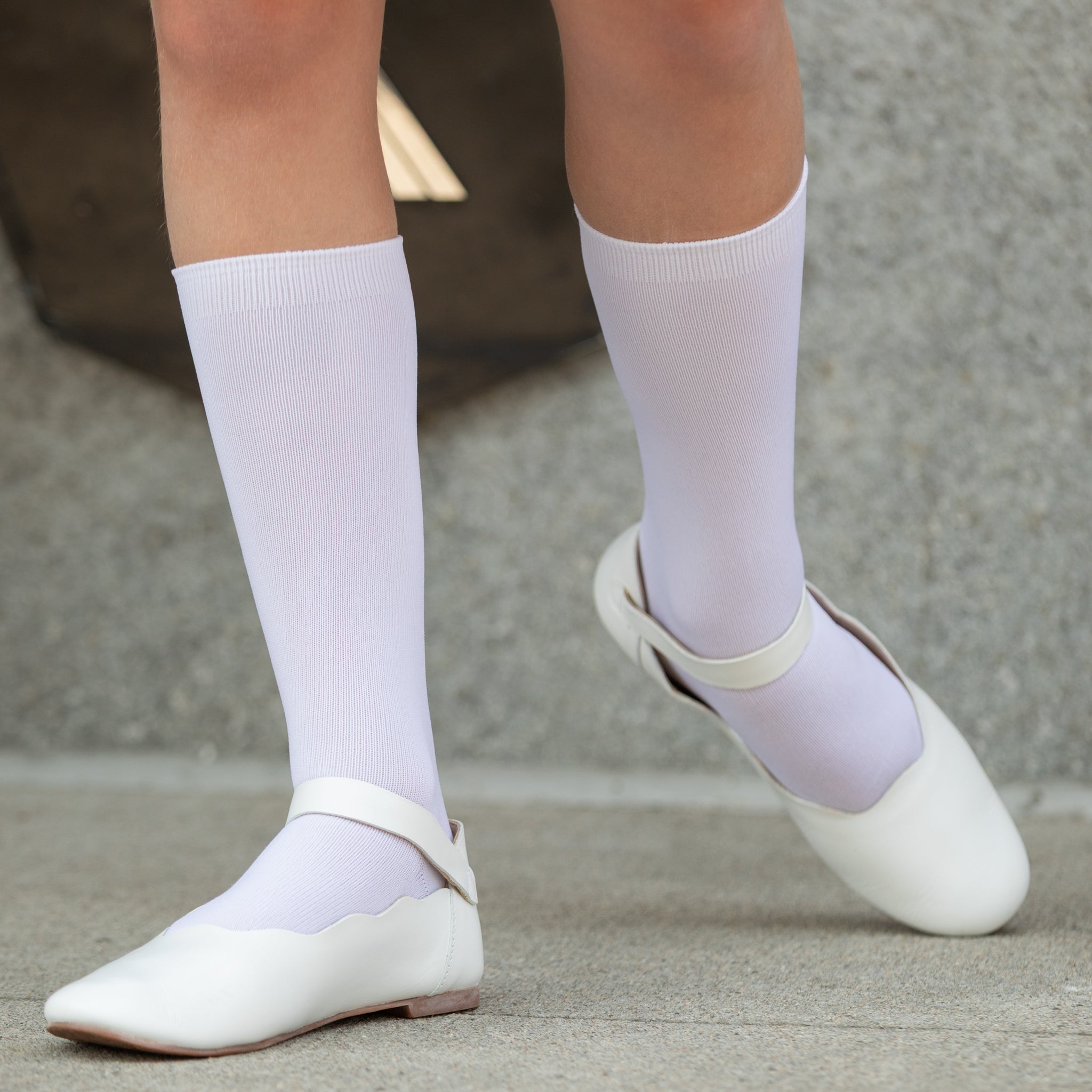 Classic white nylon knee high socks for girls and toddlers, lightweight with ribbed stay-up top, designed for comfort and perfect fit, ideal for pairing with Mary Janes or dress shoes from Henry Duvall’s Fall Collection