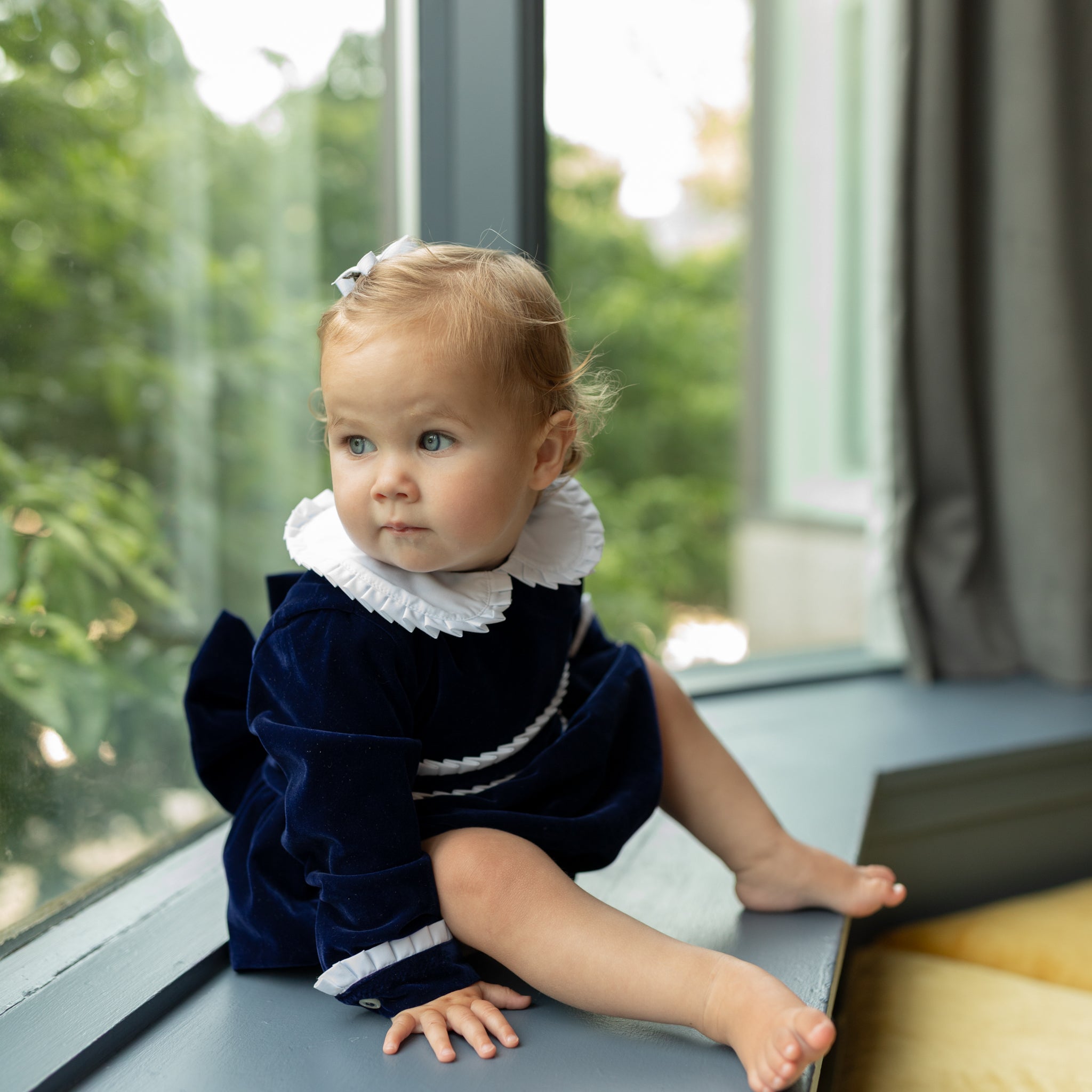 Baby girls navy velvet bubble with white pleated detailing and pre-tied bow, long sleeve fall outfit for special occasions and family photos by Henry Duvall