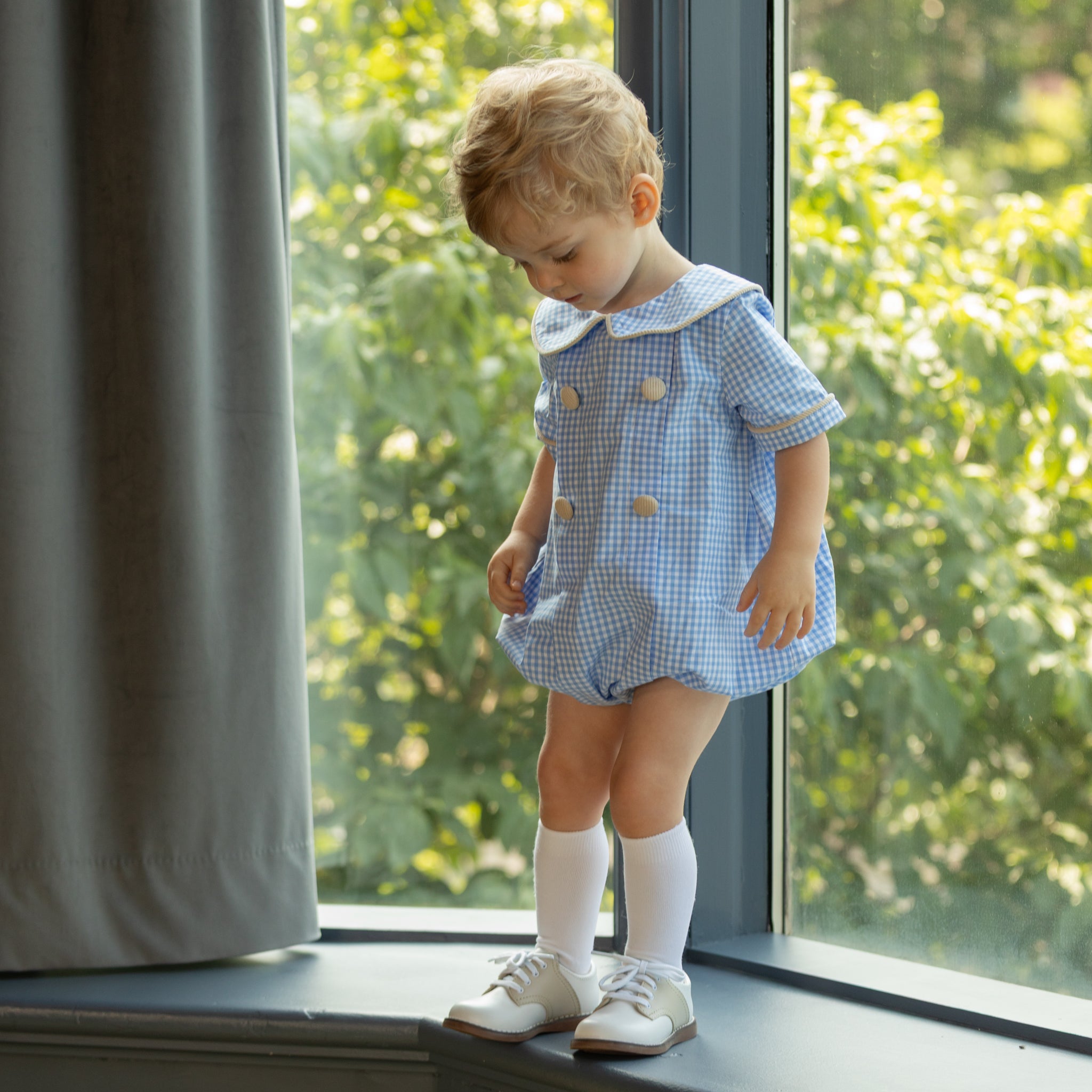 Henry Duvall Banks Bubble in classic blue Charles Street Check with King’s Way Khaki Corduroy trim, classic fall baby boy outfit with covered buttons and diaper snaps