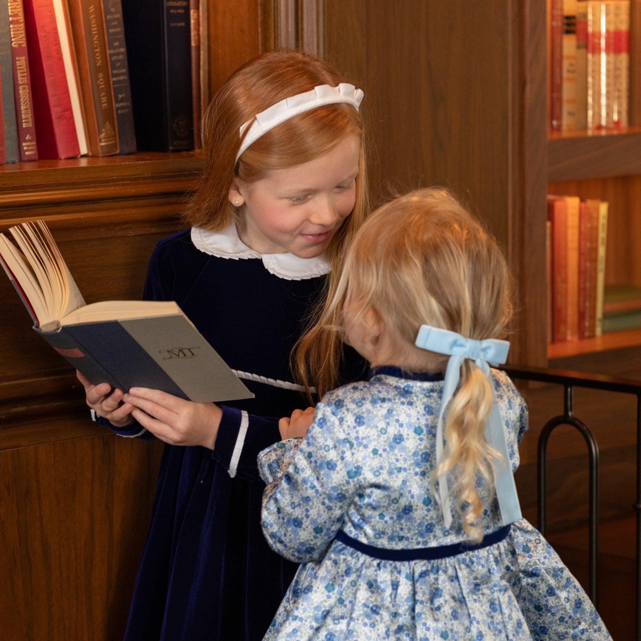 Girls long sleeve navy velvet party dress with white pleated details and pre-tied back bow, perfect for fall family photos and special occasions from Henry Duvall