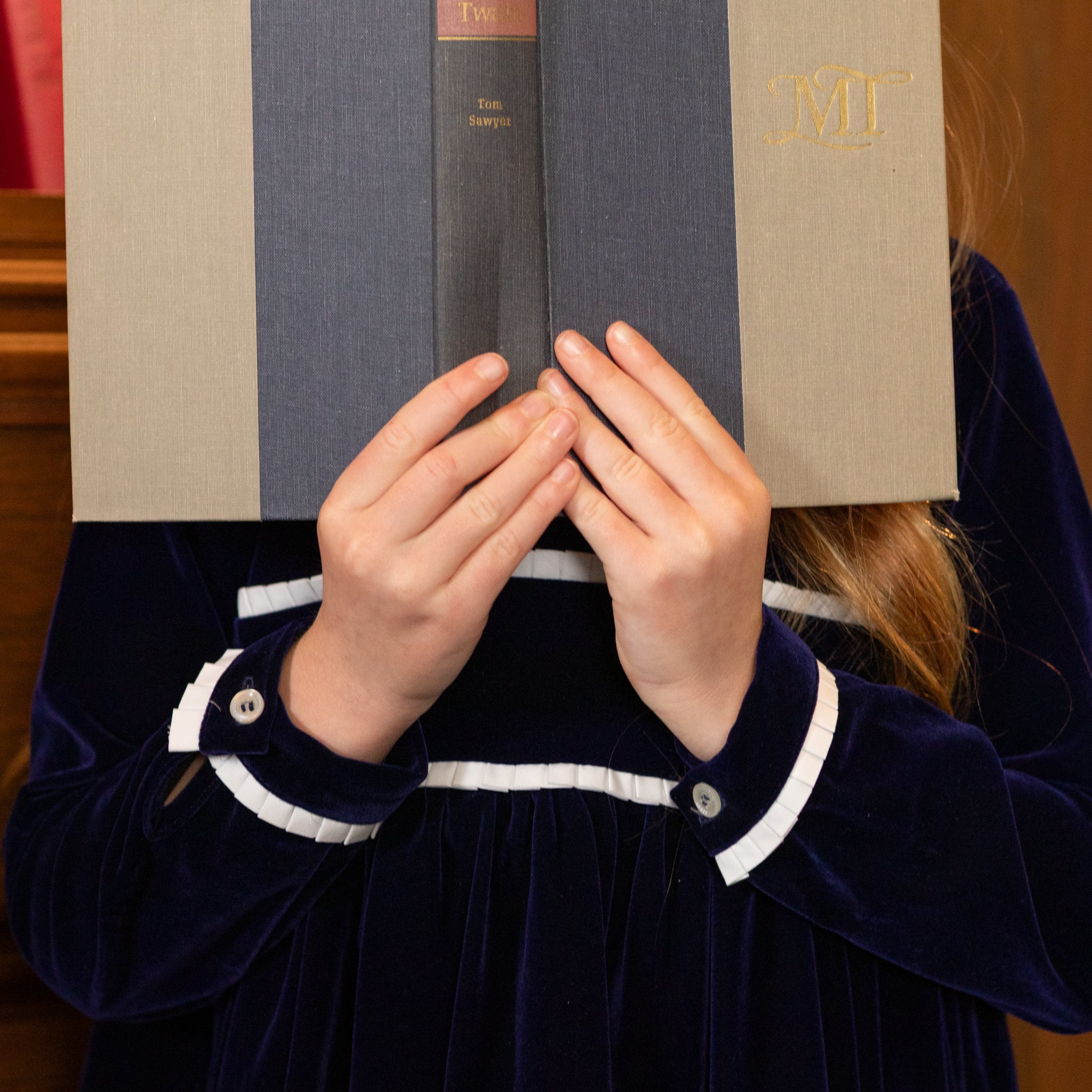 Girls long sleeve navy velvet party dress with white pleated details and pre-tied back bow, perfect for fall family photos and special occasions from Henry Duvall