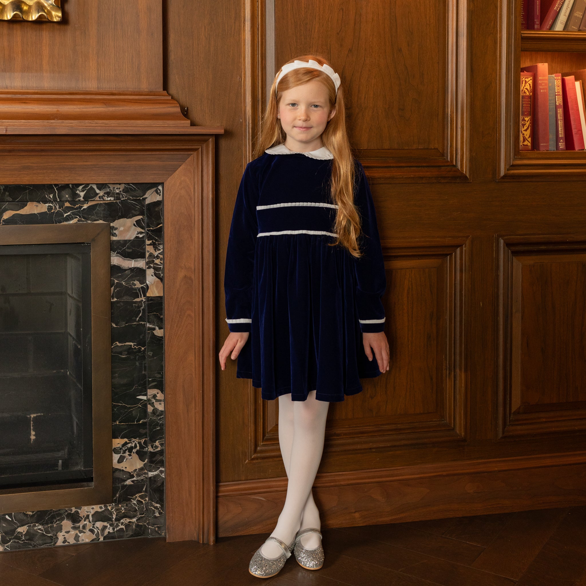 Girls long sleeve navy velvet party dress with white pleated details and pre-tied back bow, perfect for fall family photos and special occasions from Henry Duvall