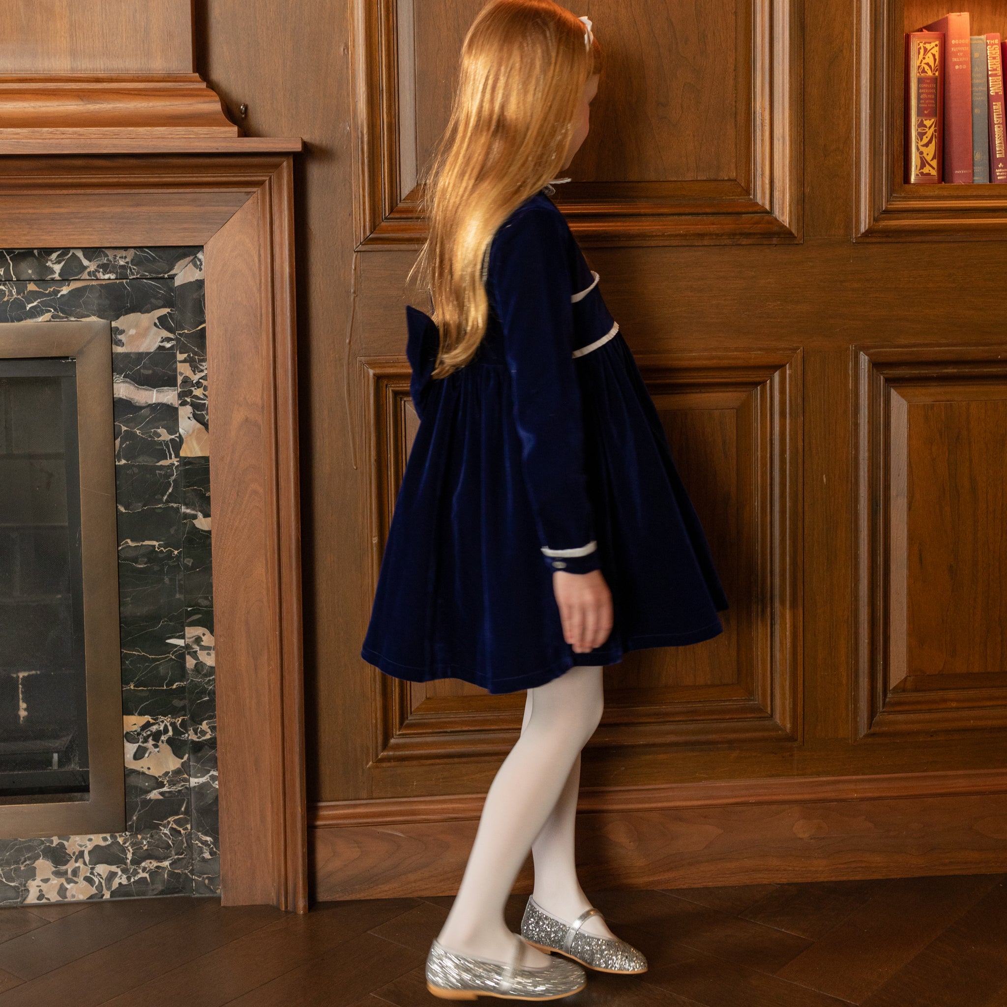 Girls long sleeve navy velvet party dress with white pleated details and pre-tied back bow, perfect for fall family photos and special occasions from Henry Duvall