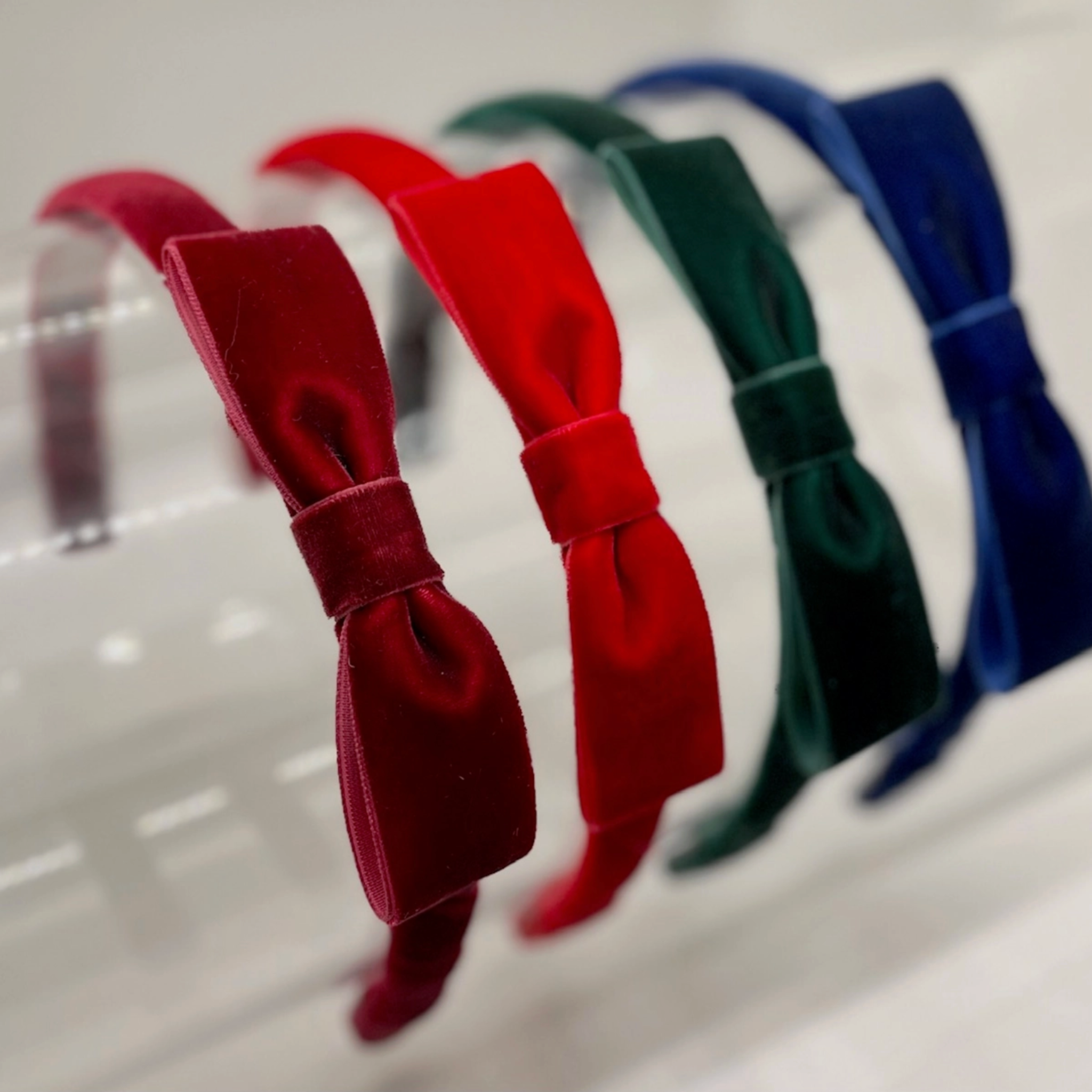 Set of red, green, and blue hair bows on a white background