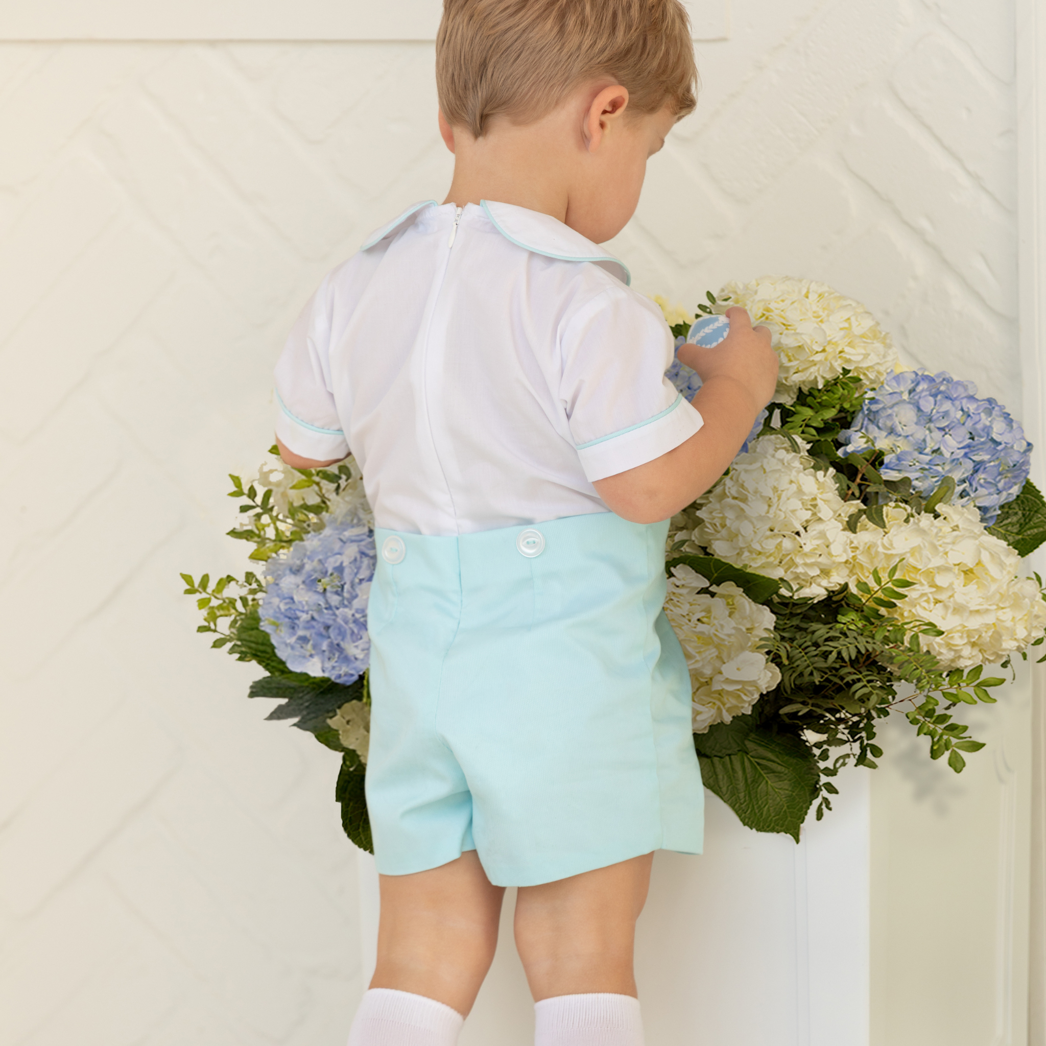 Toddler boy wearing the Henry Duvall Benjamin Button-On, a traditional heirloom-style outfit designed for special occasions and family photos.