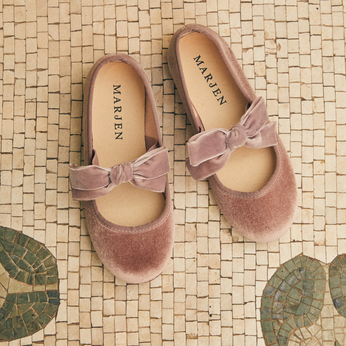 Andie Rose velvet Mary Jane in rose pink with velvet bow, pair on a mosaic floor