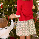 Girls’ Sutton Skirt in Regent Wreaths, featuring a festive green wreath and red star print on white with a full gathered silhouette.