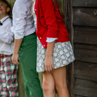 Girls’ Sutton Skirt in Regent Wreaths, featuring a festive green wreath and red star print on white with a full gathered silhouette.