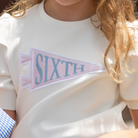 Henry Duvall Pennant Tee featuring appliqué grade pennant, classic back-to-school shirt for kindergarten through fifth grade, perfect for first day of school photos and school milestone celebrations.