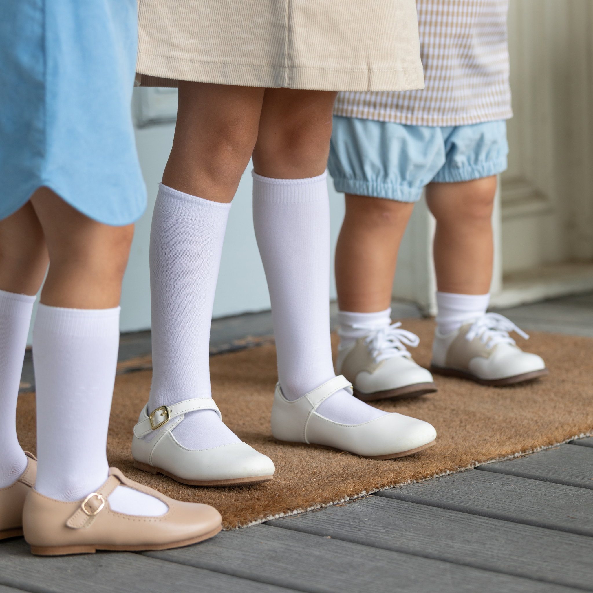Classic white nylon knee high socks for girls and toddlers, lightweight with ribbed stay-up top, designed for comfort and perfect fit, ideal for pairing with Mary Janes or dress shoes from Henry Duvall’s Fall Collection