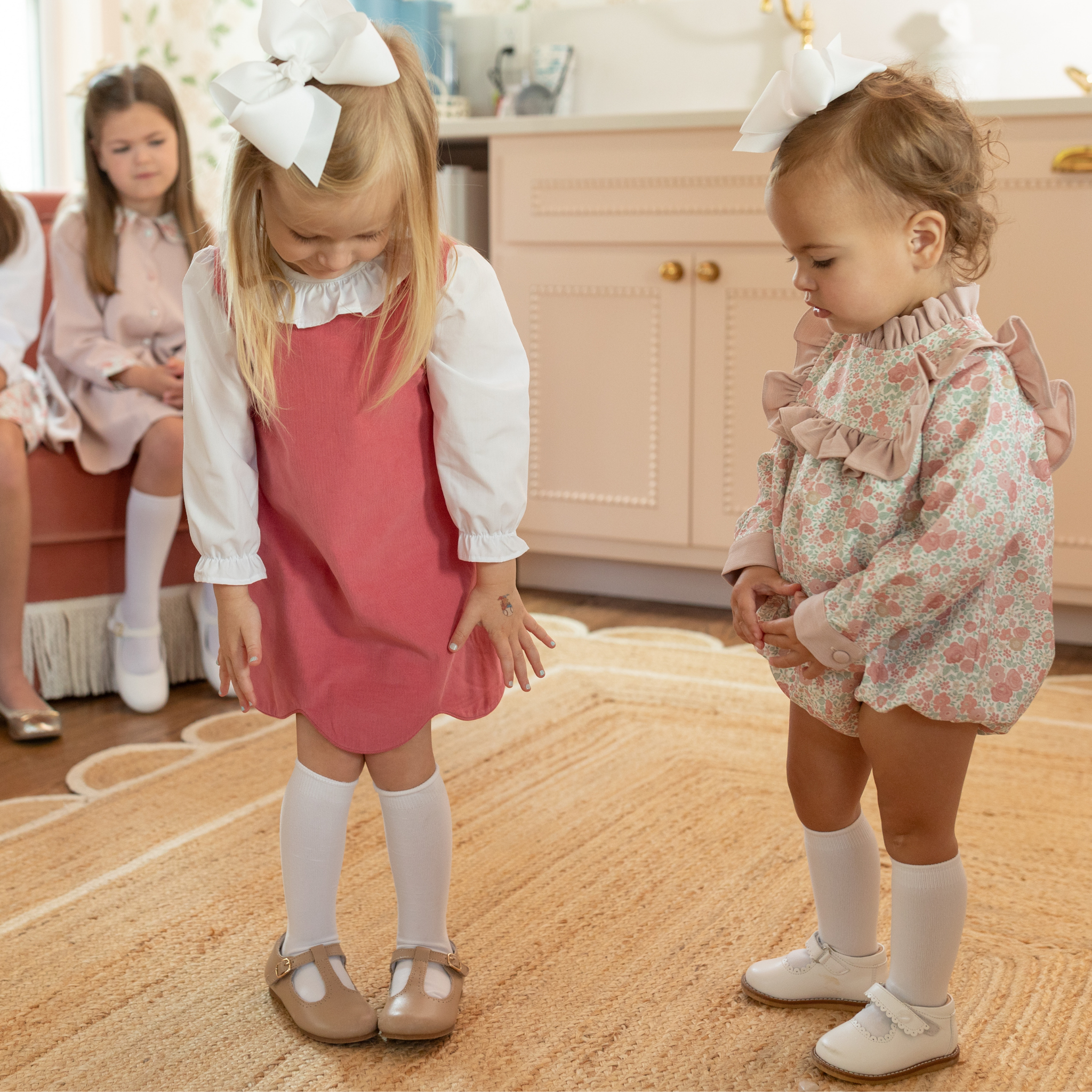 Henry Duvall Janey Jumper girls’ dress in Fall Floral with scalloped hem and fabric-covered shoulder buttons, designed for layering with blouses and turtlenecks for fall.