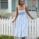 Woman wearing the Henry Duvall Kate Dress, a breezy striped women’s dress with coastal style.