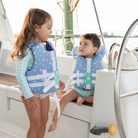 Stylish Henry Duvall x Line + Cleat infant life jacket in blue star print with neck pillow support, zipper front, and adjustable straps