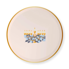 Round cream-colored Hanukkah paper plate with a gold rim and a central illustration of a golden menorah surrounded by soft blue florals, designed by Bonjour Fête x One & Only Paper
